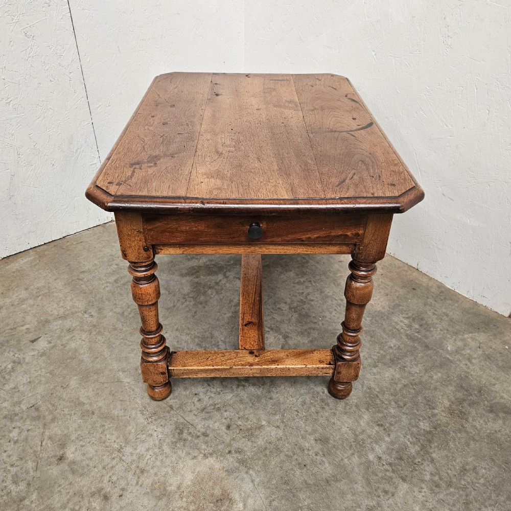 A small antique French walnut end table featuring turned wooden legs, a low stretcher base, and a single drawer with a dark turned knob. View II