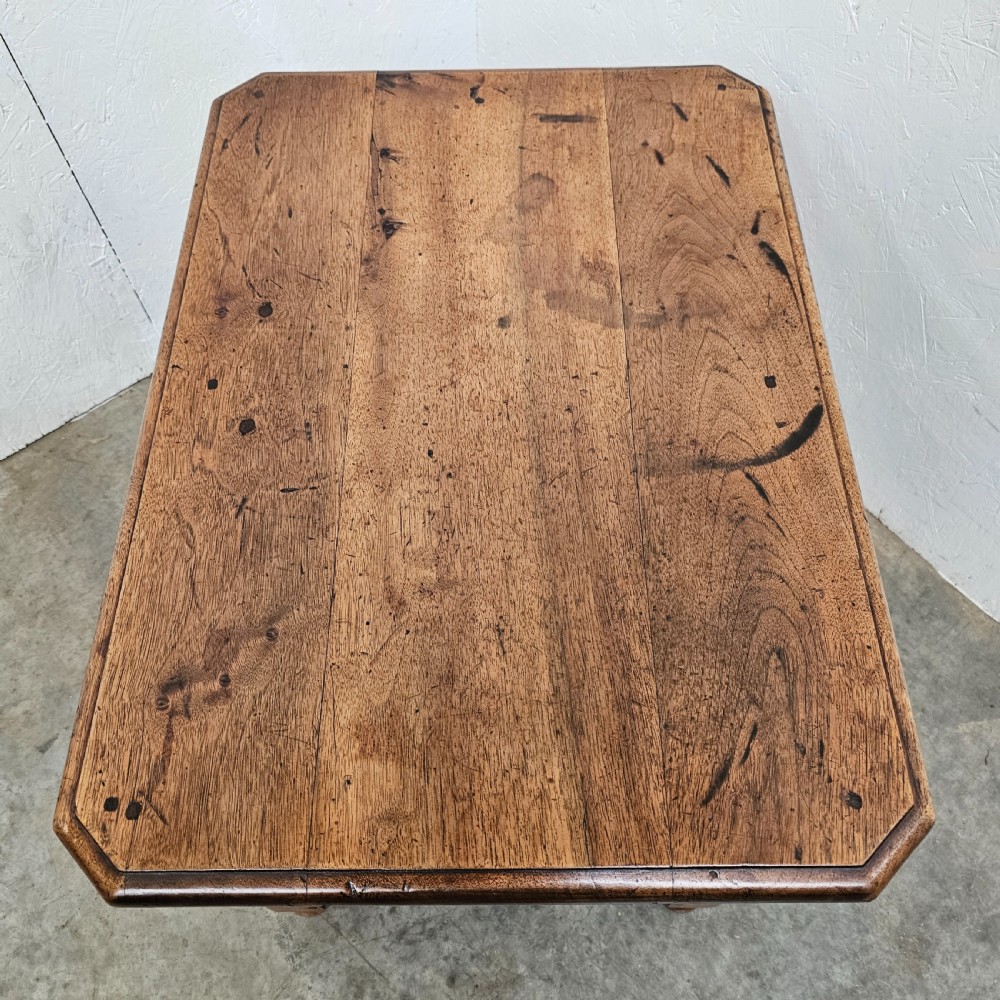 A small antique French walnut end table featuring turned wooden legs, a low stretcher base, and a single drawer with a dark turned knob. View V