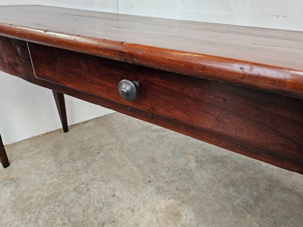 An exceptionally long French rustic wooden console table featuring two frieze drawers and simple tapered legs. View VII