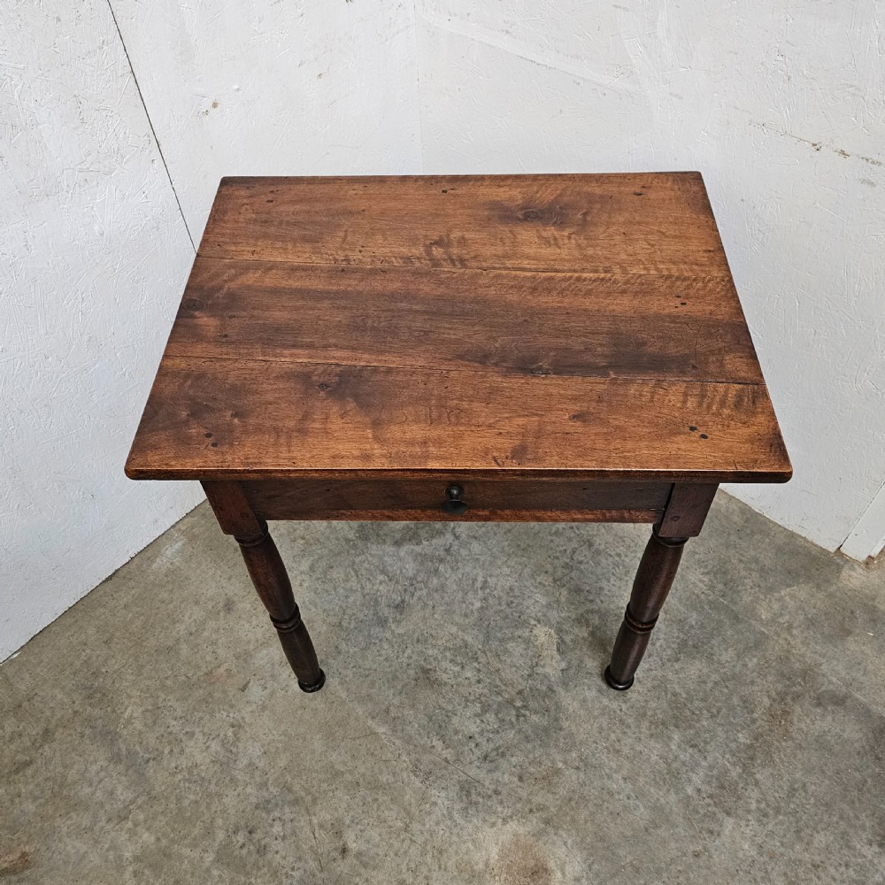 An early 19th-century walnut lamp table featuring a single drawer with a dark wooden knob handle and four turned legs. View III