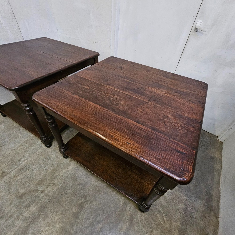 A matching pair of dark French oak square low display tables featuring turned legs and a solid lower tier shelf. View VI