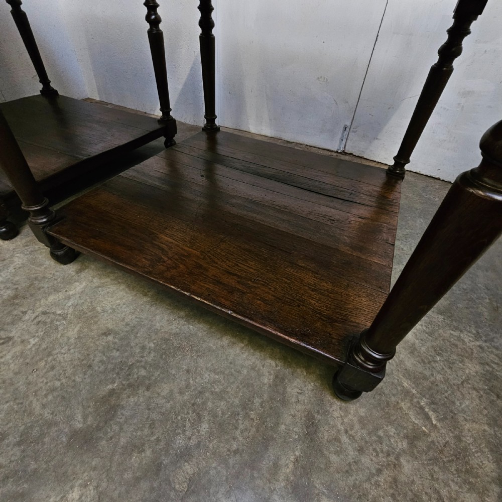 A matching pair of dark French oak square low display tables featuring turned legs and a solid lower tier shelf. View II