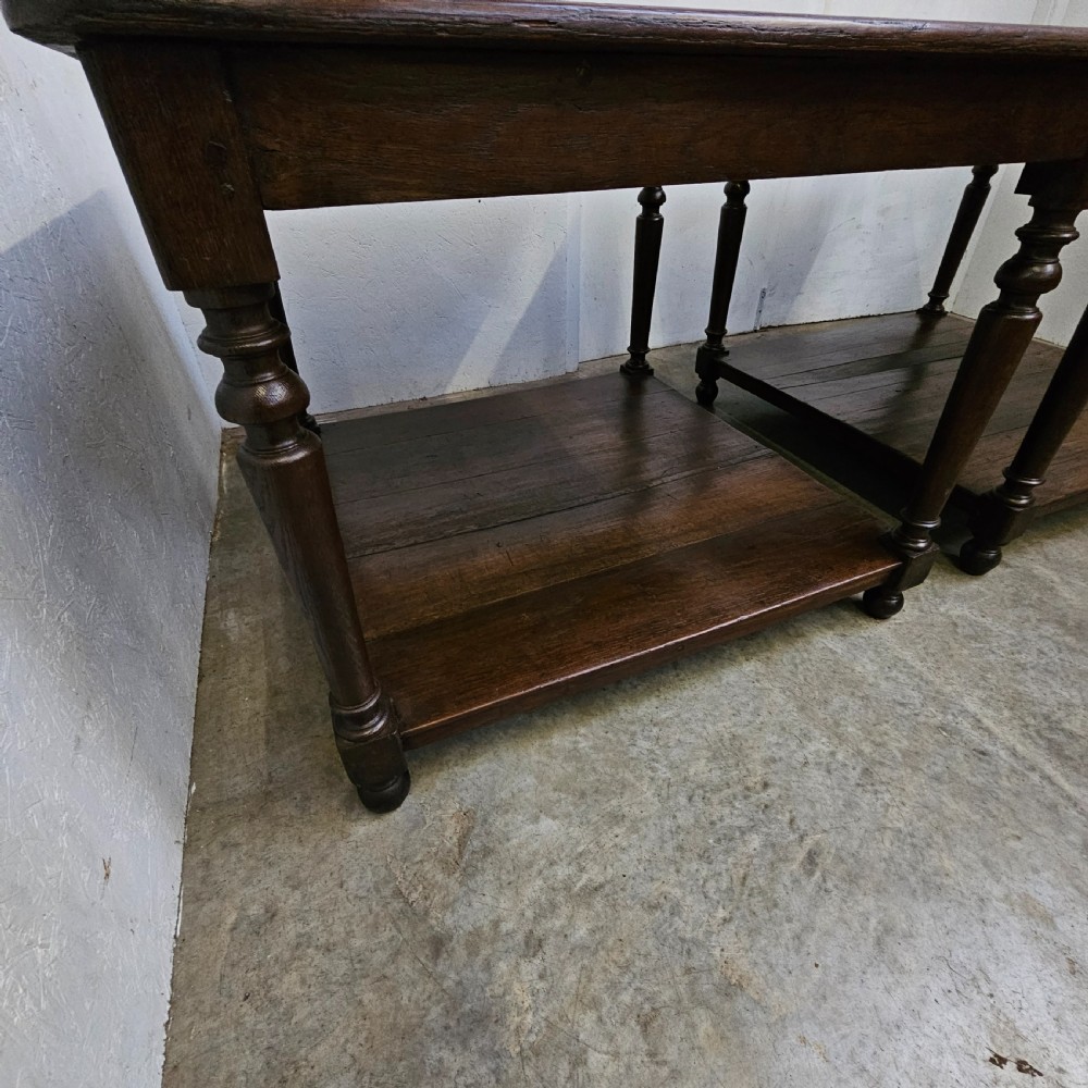 A matching pair of dark French oak square low display tables featuring turned legs and a solid lower tier shelf. View IV