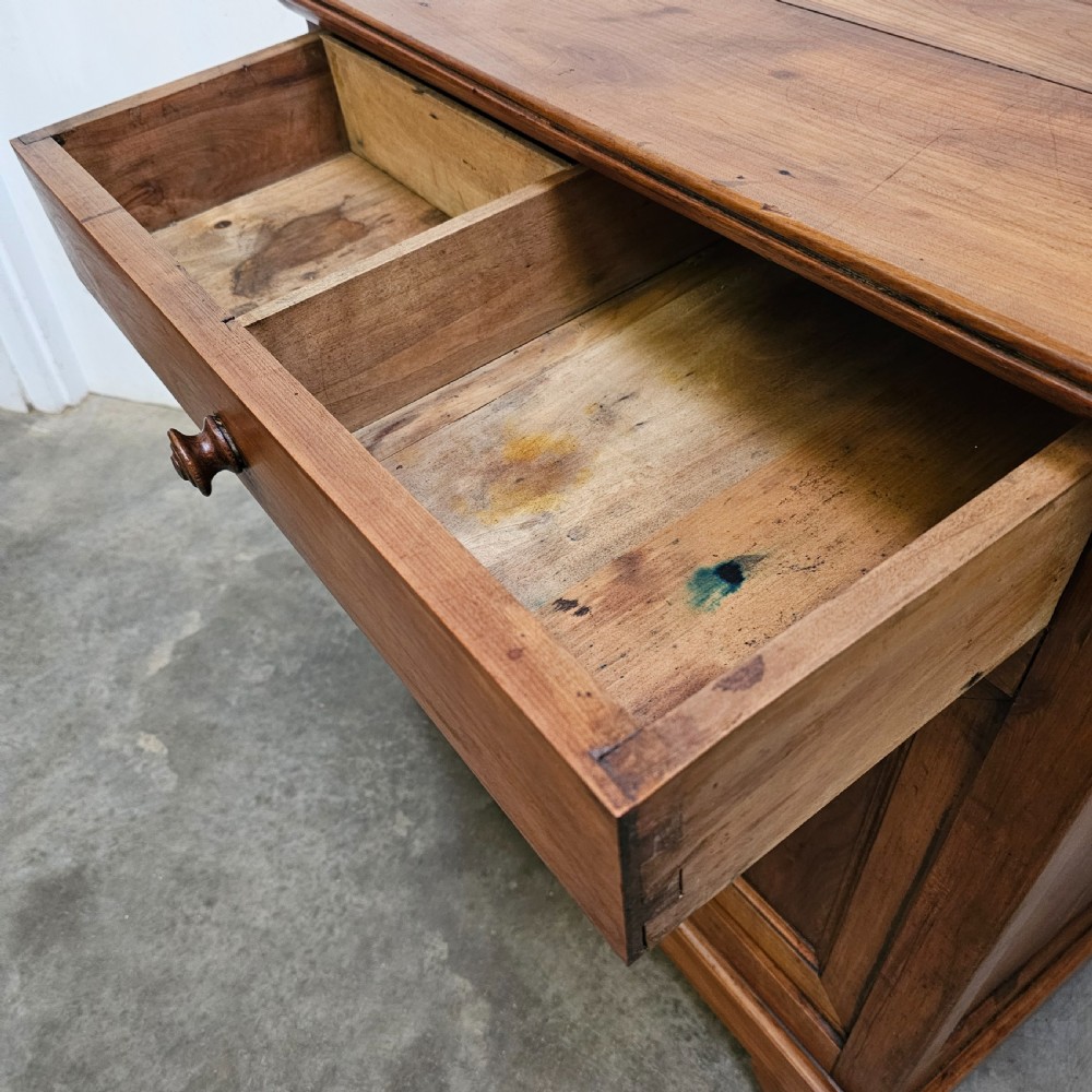 A 19th-century French provincial cherry wood buffet with a single full-width drawer above a two-door cabinet with turned wooden knobs. View II