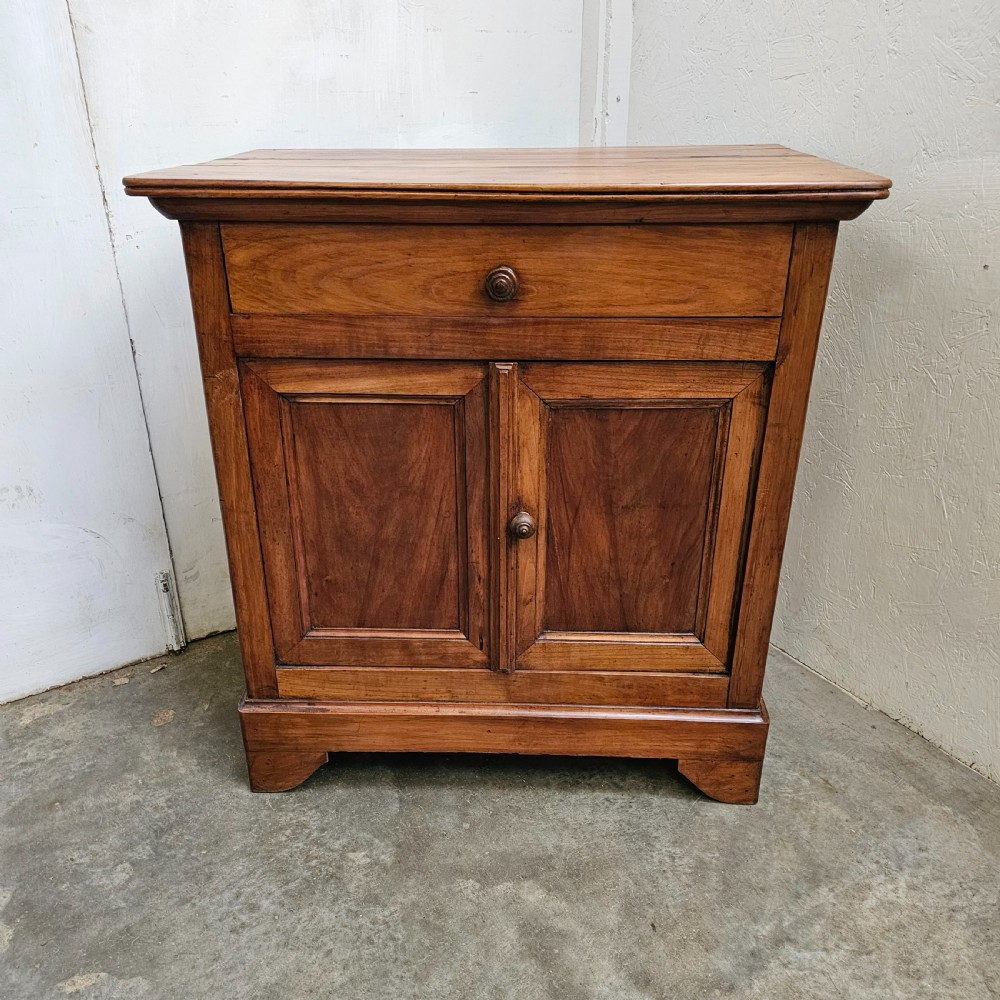 A 19th-century French provincial cherry wood buffet with a single full-width drawer above a two-door cabinet with turned wooden knobs.