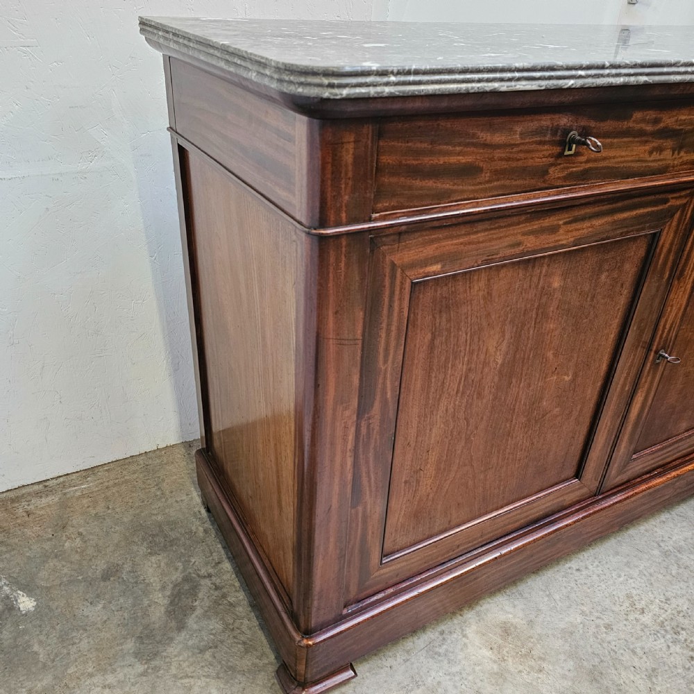 A French Louis Philippe style mahogany buffet with a grey veined marble top, two upper drawers, and two panelled cabinet doors. View IV