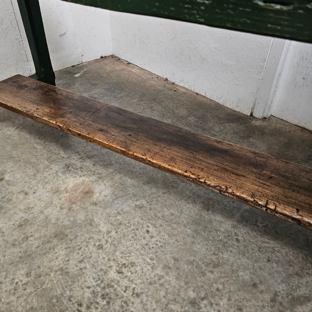 A long rustic French serving table featuring a dark green painted wooden frame, a single drawer with an iron pull, a natural wood top, and a lower pot shelf. View VII