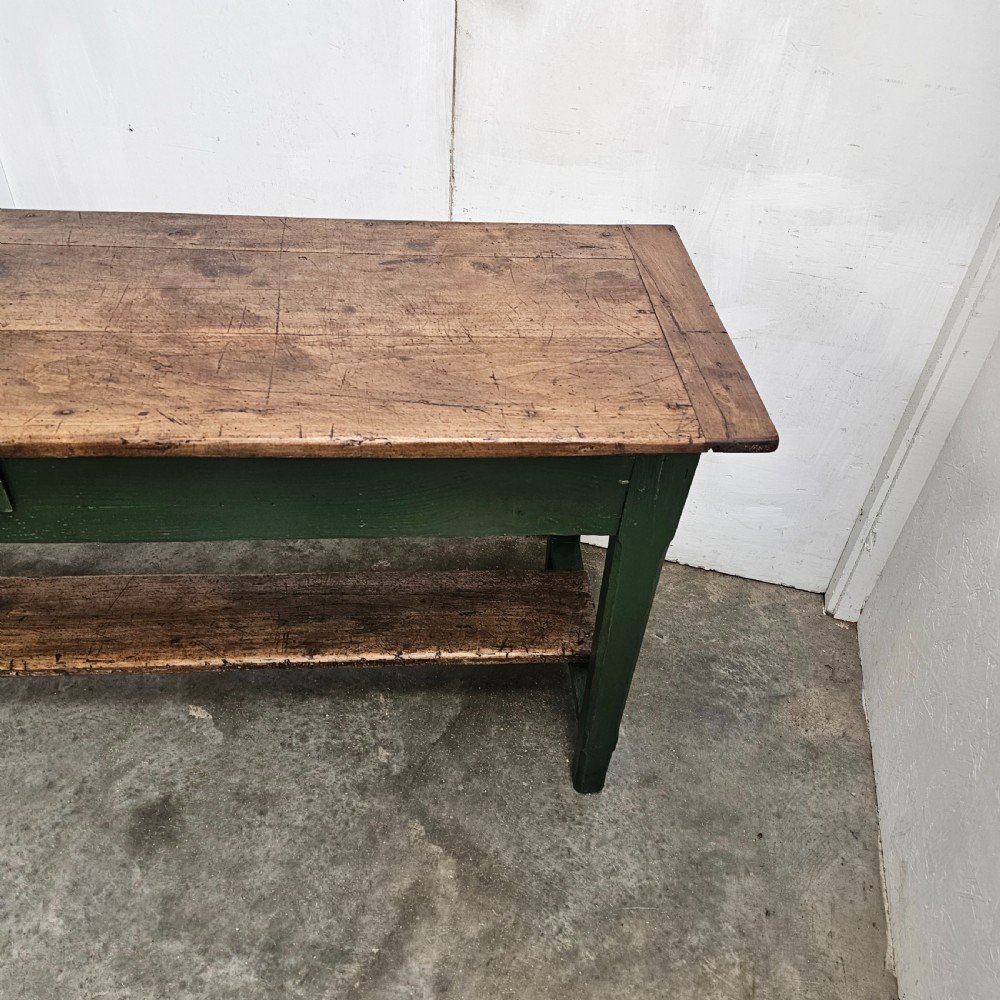A long rustic French serving table featuring a dark green painted wooden frame, a single drawer with an iron pull, a natural wood top, and a lower pot shelf. View II