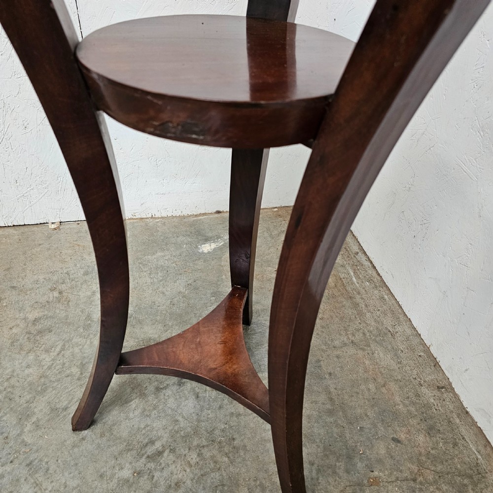 A tall French mahogany tripod stand featuring an inset circular white marble top with a pierced brass gallery and a lower circular shelf. View VI