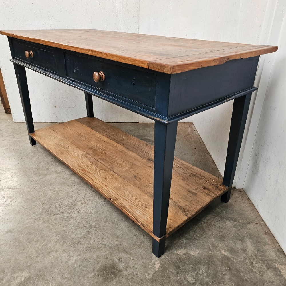 A French two-tier wooden work table featuring a dark blue painted frame, two drawers with round wooden handles, and natural light wood top and lower shelf. View IV