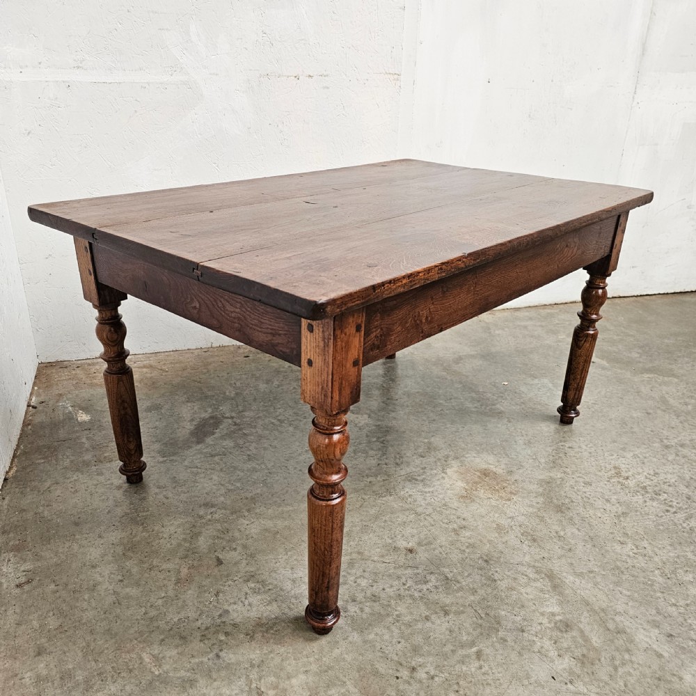 A low rectangular French oak table featuring a flat wooden top, deep apron, and four turned legs. View II