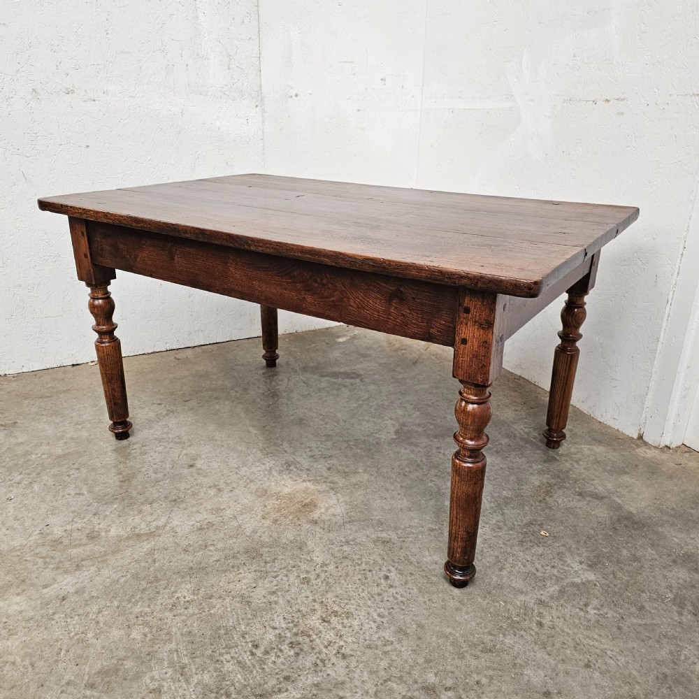 A low rectangular French oak table featuring a flat wooden top, deep apron, and four turned legs. View IV