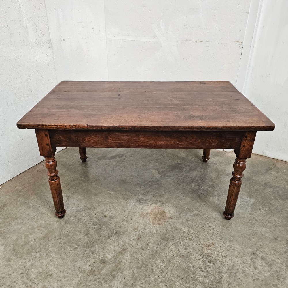 A low rectangular French oak table featuring a flat wooden top, deep apron, and four turned legs. View VI