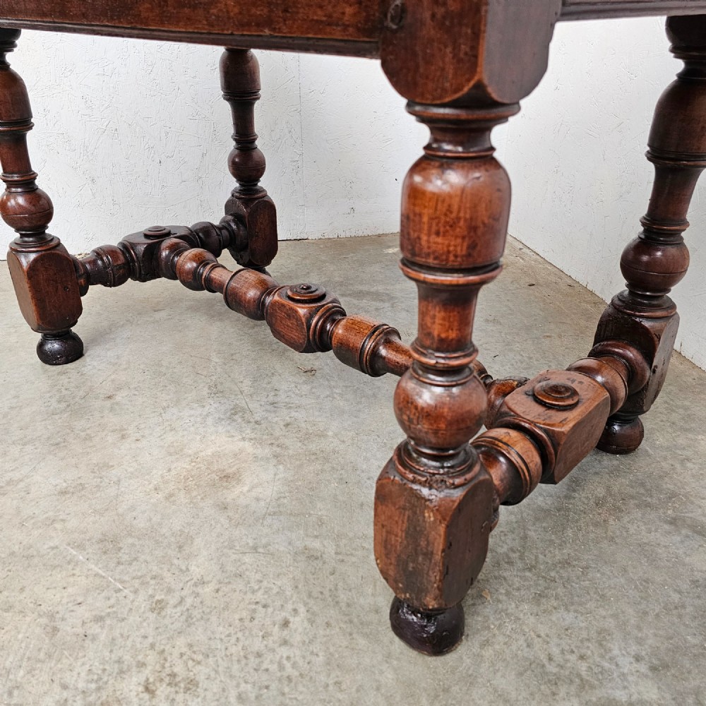 A warm brown cherry wood side table with turned legs, a low stretcher, and a single frieze drawer with a brass handle. View V