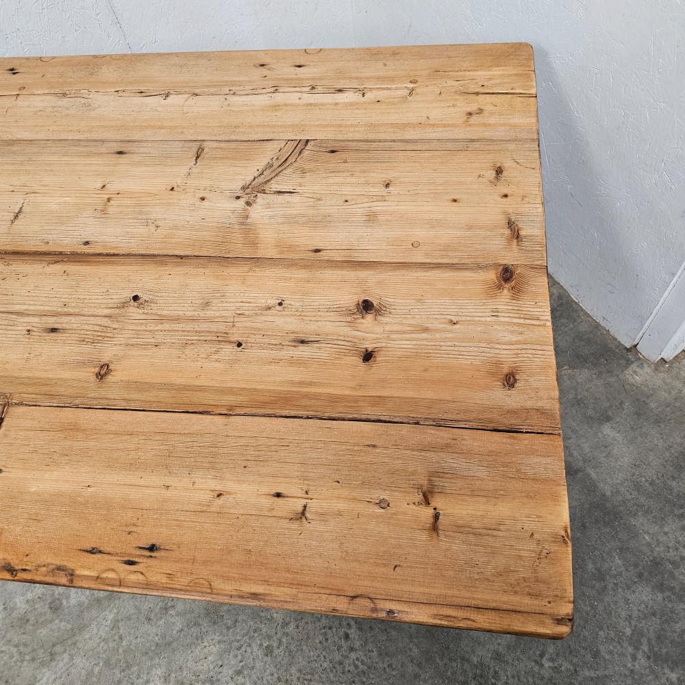 An antique table featuring an unvarnished scrubbed pine tabletop supported by a dark fruitwood base with square tapered legs. View IV