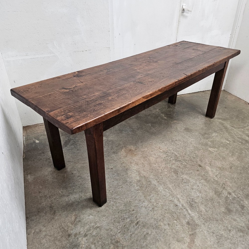 A long antique dark oak tavern table featuring a thick planked timber top supported by sturdy square legs. View II