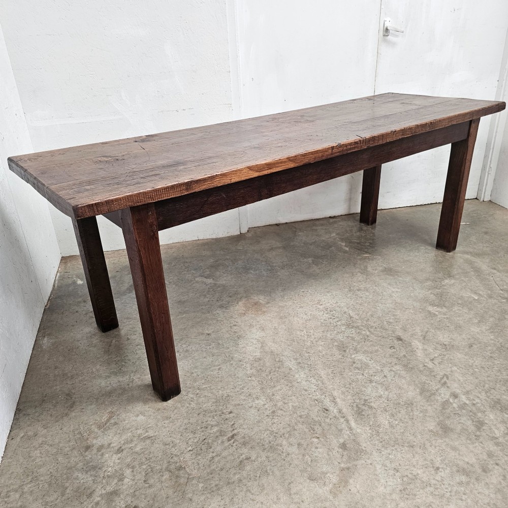 A long antique dark oak tavern table featuring a thick planked timber top supported by sturdy square legs. View IV
