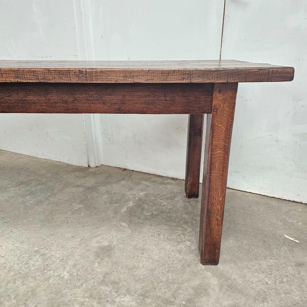 A long antique dark oak tavern table featuring a thick planked timber top supported by sturdy square legs. View VI