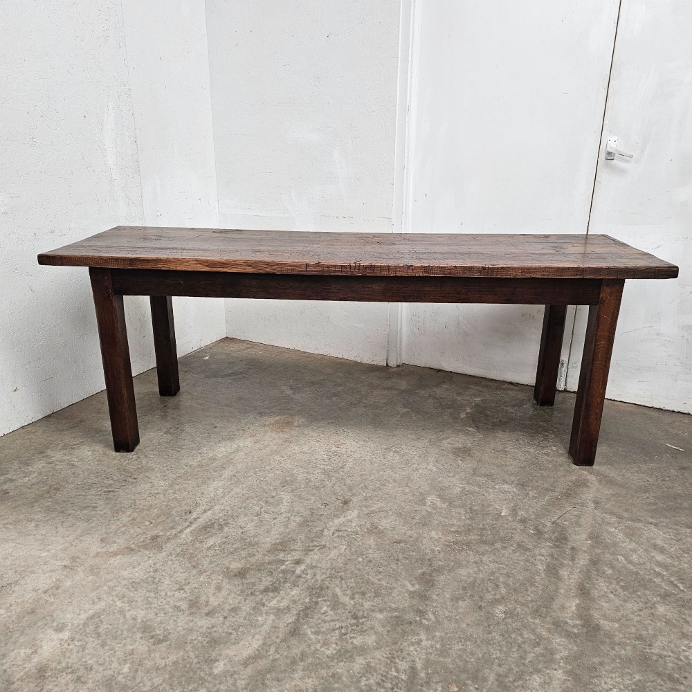 A long antique dark oak tavern table featuring a thick planked timber top supported by sturdy square legs. View VII