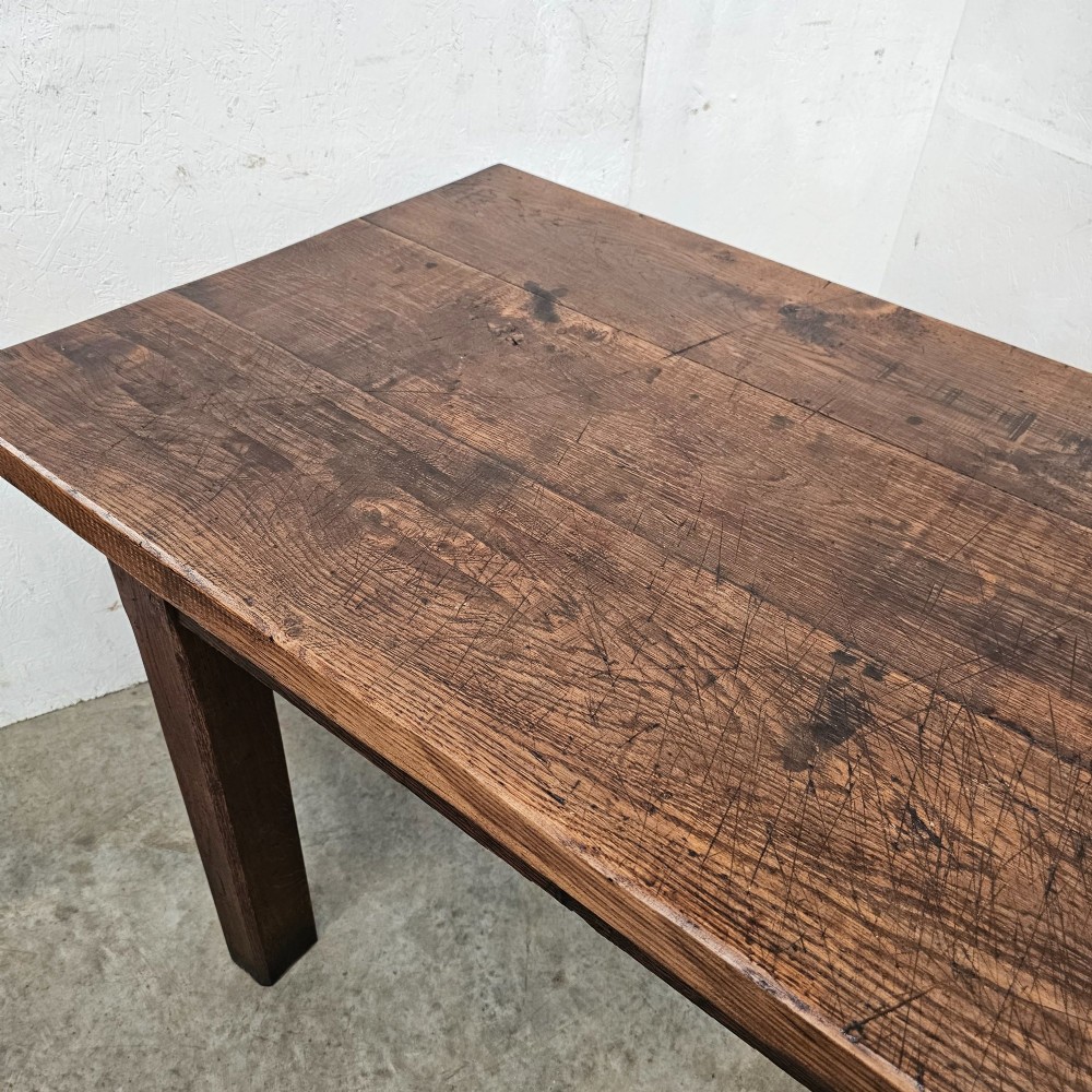 A long antique dark oak tavern table featuring a thick planked timber top supported by sturdy square legs. View IX