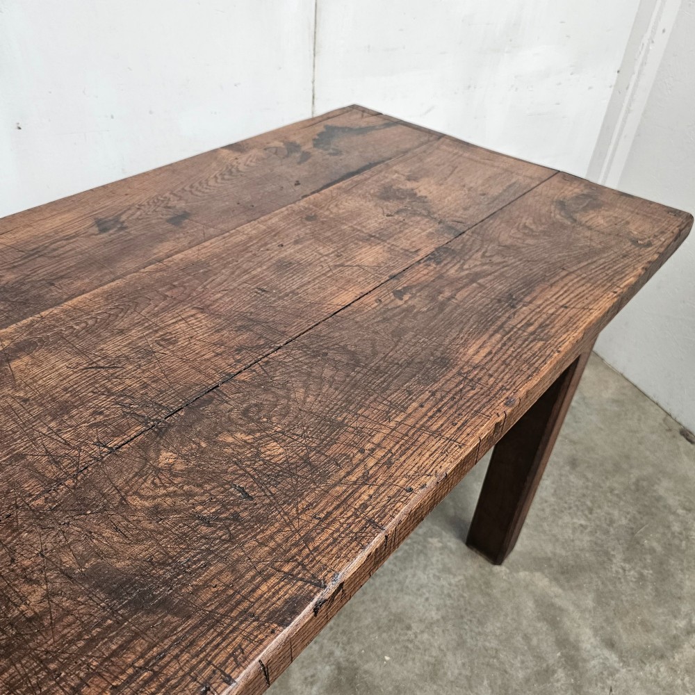 A long antique dark oak tavern table featuring a thick planked timber top supported by sturdy square legs. View X