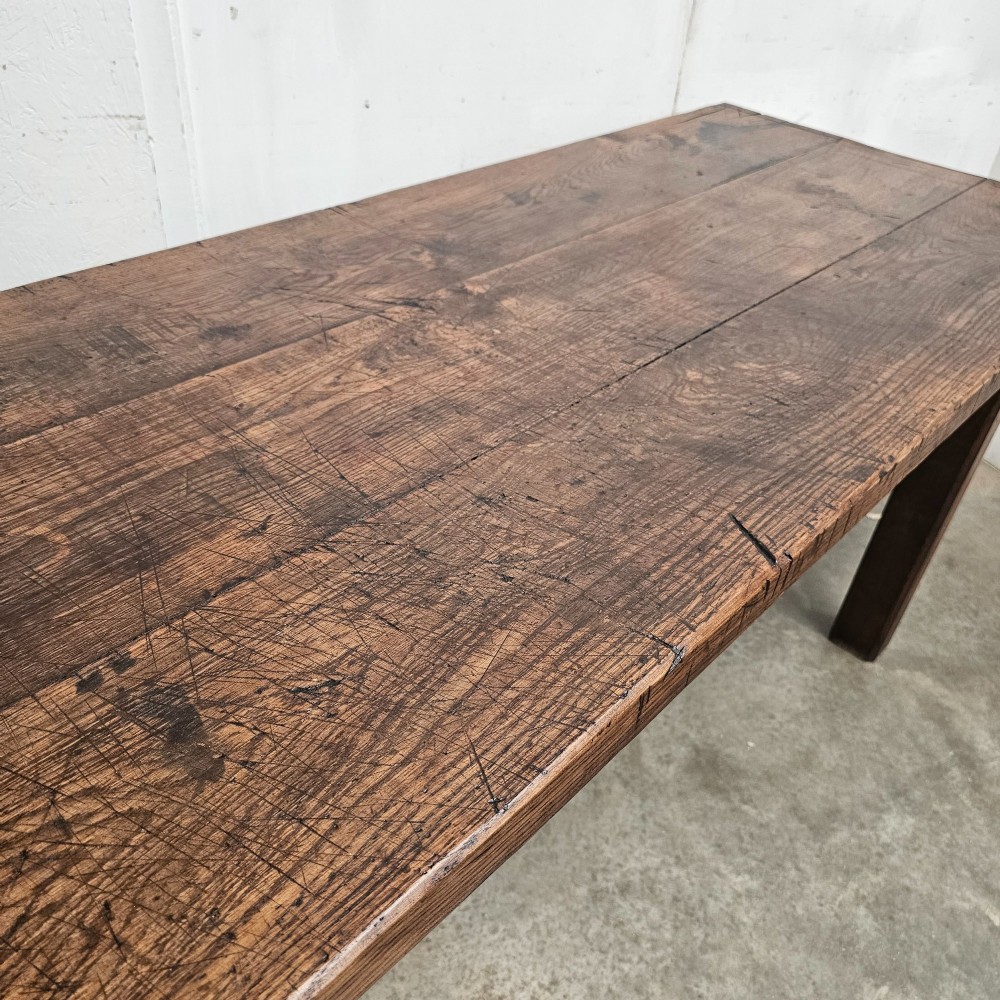 A long antique dark oak tavern table featuring a thick planked timber top supported by sturdy square legs. View XI