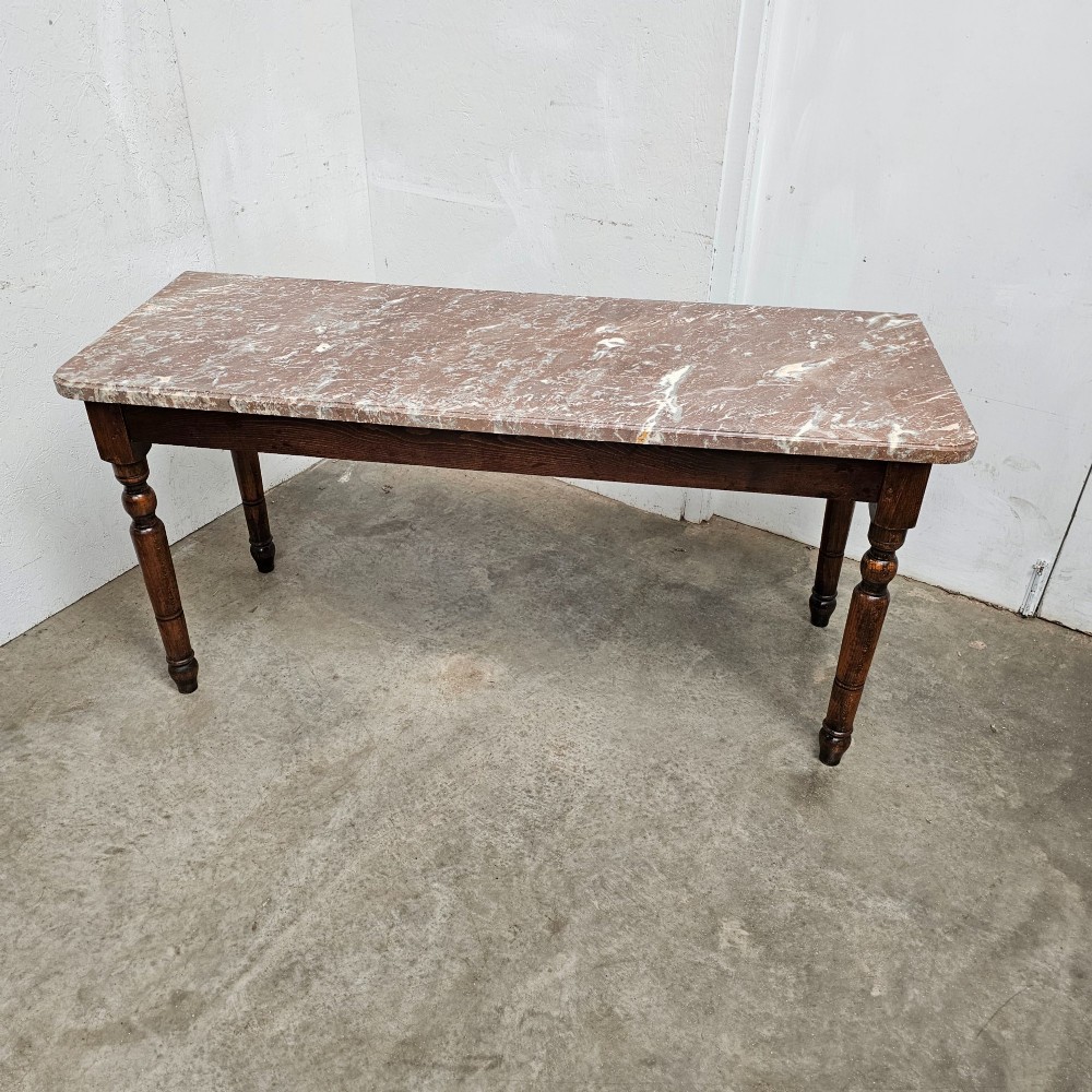 A French patisserie table featuring a thick reddish veined marble top supported by a dark wood frame with four turned legs. View IV