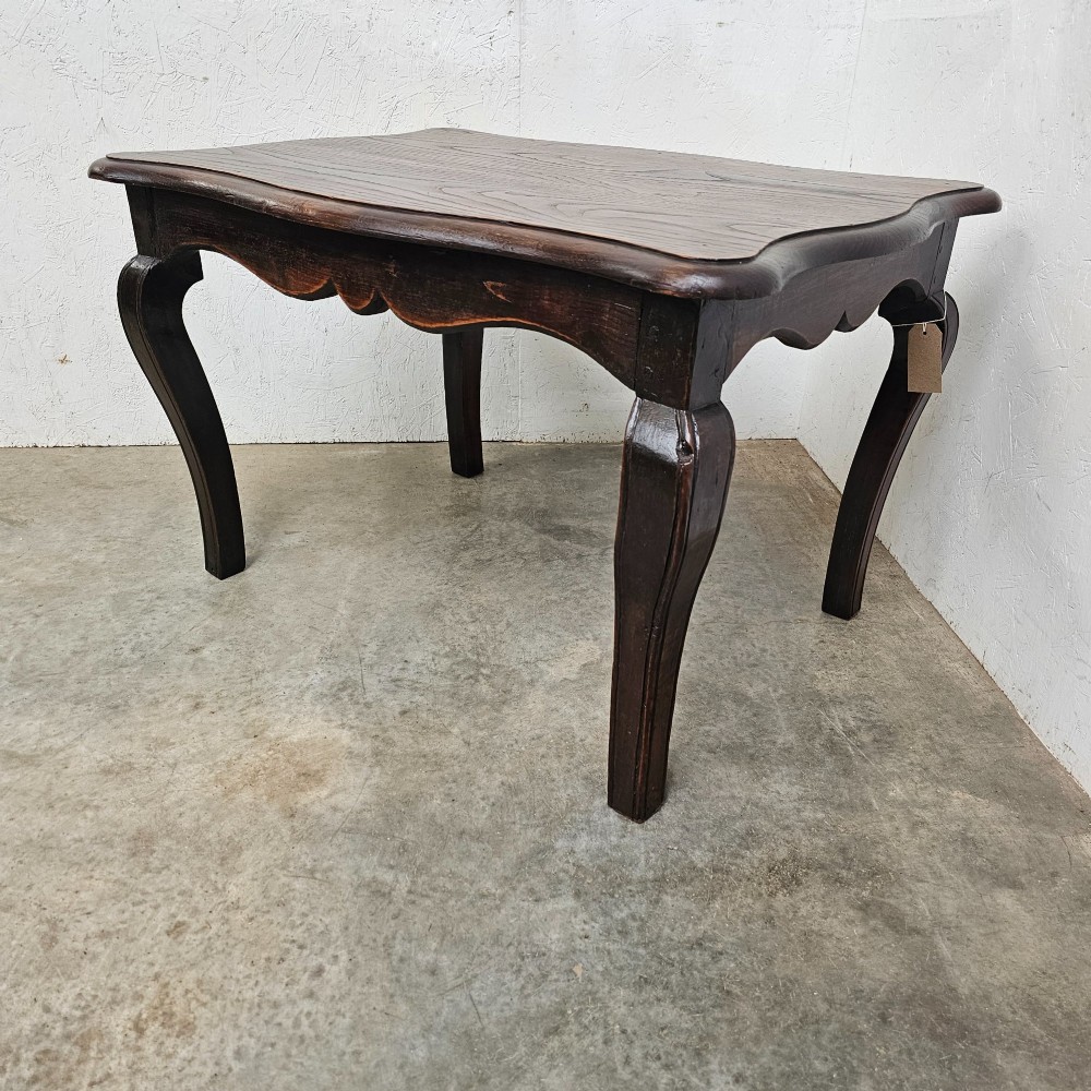 A dark brown French provincial chestnut low table featuring cabriole legs and a contoured apron. View II