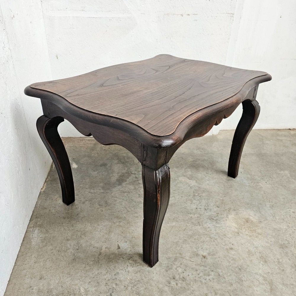 A dark brown French provincial chestnut low table featuring cabriole legs and a contoured apron. View VI