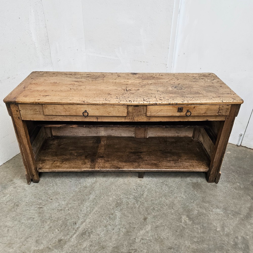 A large rectangular timber shop counter featuring a distressed yellow painted frame with a moulded front panel and a natural wood top. View VI