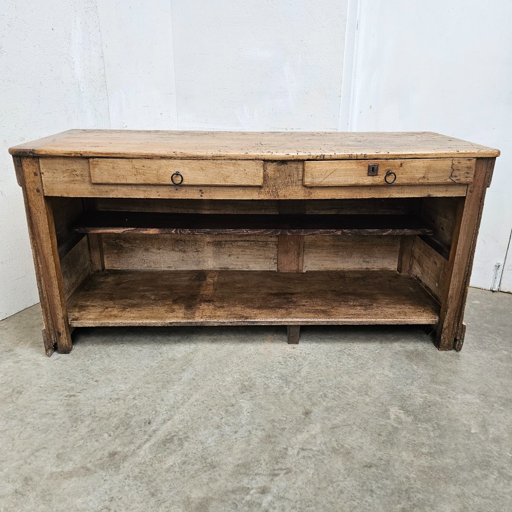 A large rectangular timber shop counter featuring a distressed yellow painted frame with a moulded front panel and a natural wood top. View VII