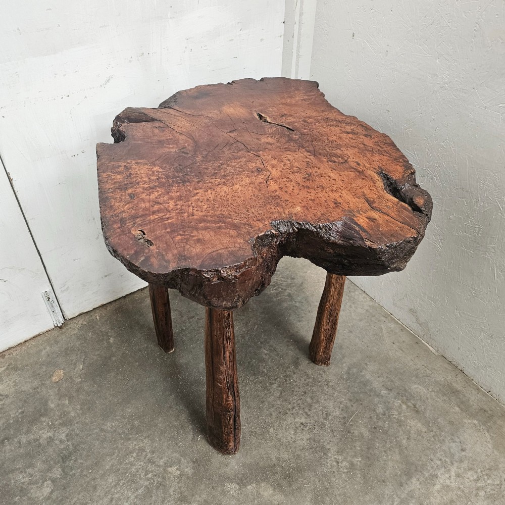 A primitive side table featuring a thick burr thuya timber slab top with natural live edges, supported by four simple wooden legs. View III