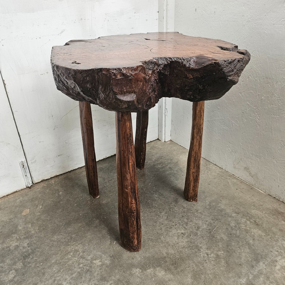 A primitive side table featuring a thick burr thuya timber slab top with natural live edges, supported by four simple wooden legs. View IV