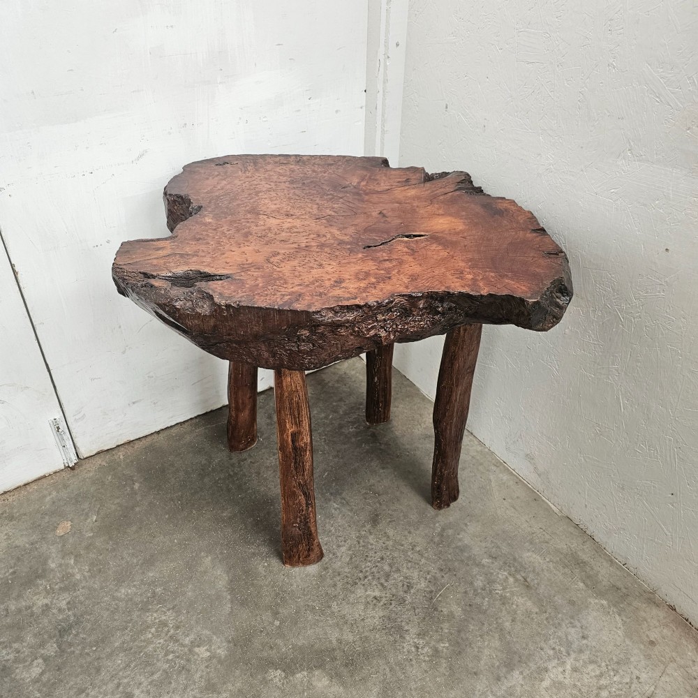 A primitive side table featuring a thick burr thuya timber slab top with natural live edges, supported by four simple wooden legs. View VII