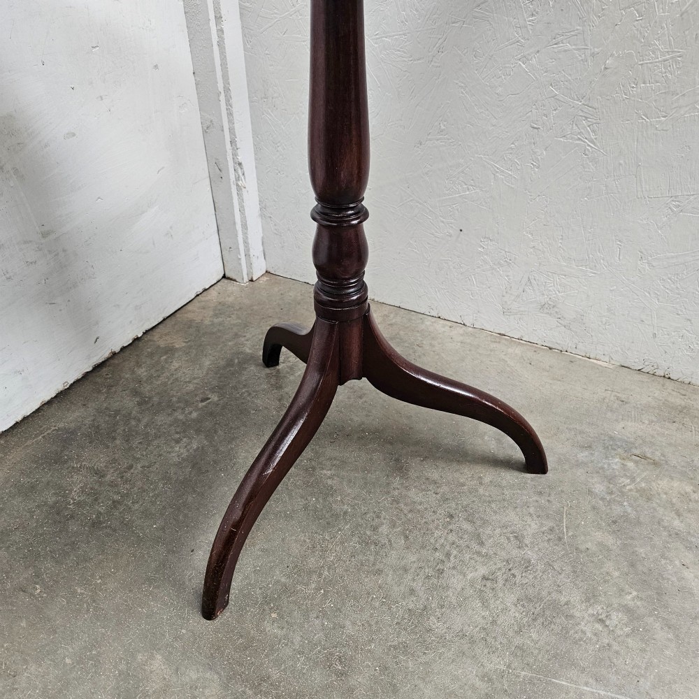 An English mahogany wine table featuring a rounded rectangular top supported by a turned central column and a three-legged tripod base. View II