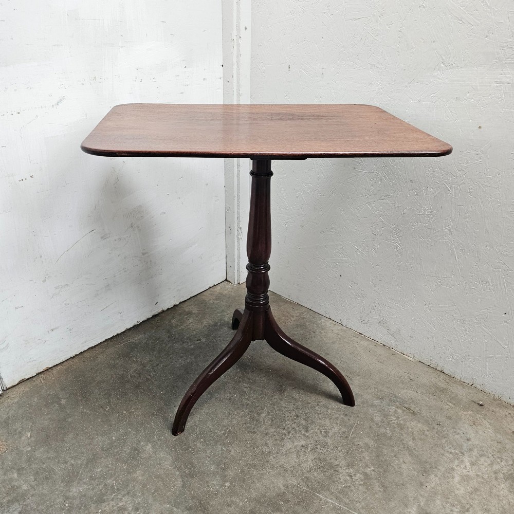 An English mahogany wine table featuring a rounded rectangular top supported by a turned central column and a three-legged tripod base. View III