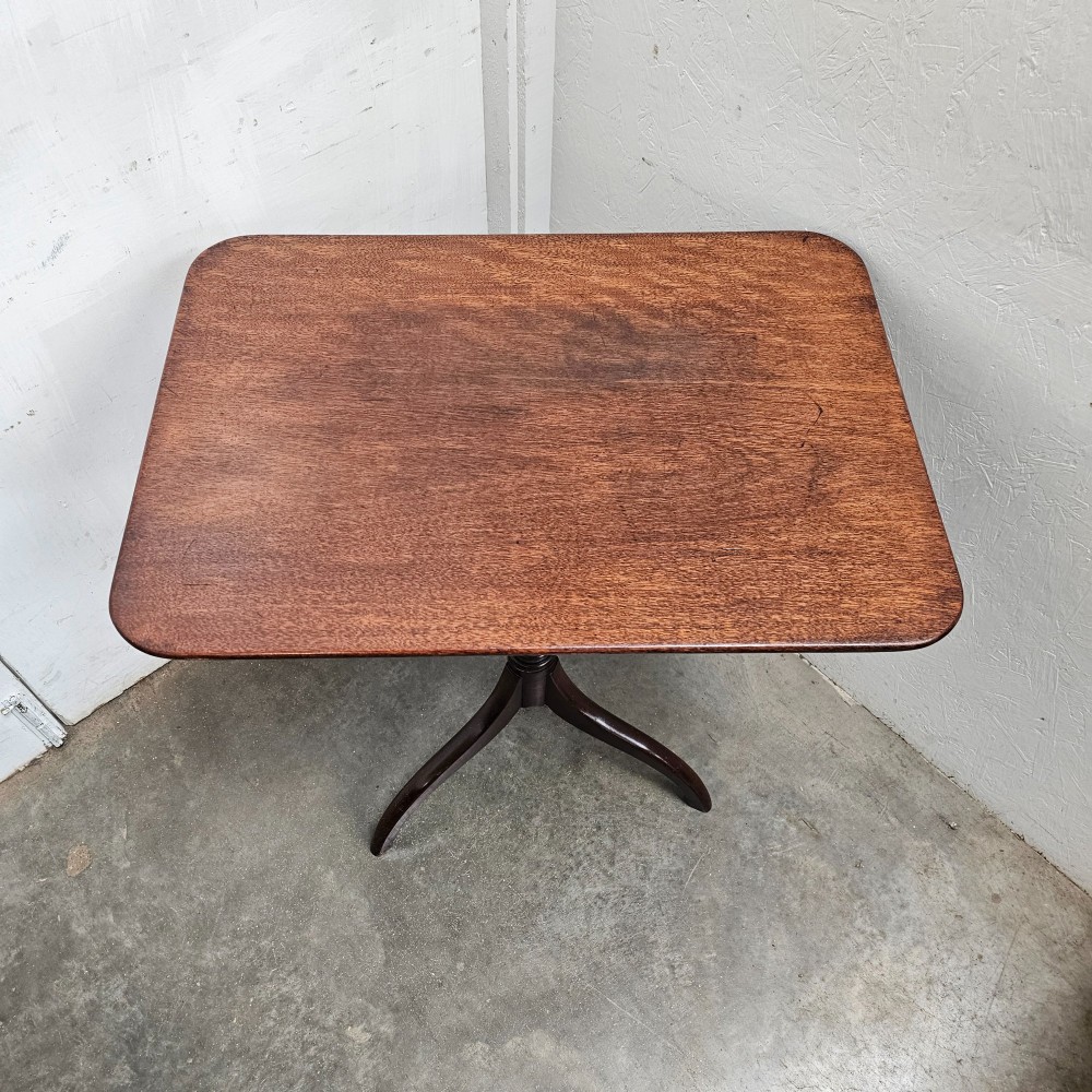 An English mahogany wine table featuring a rounded rectangular top supported by a turned central column and a three-legged tripod base. View IV