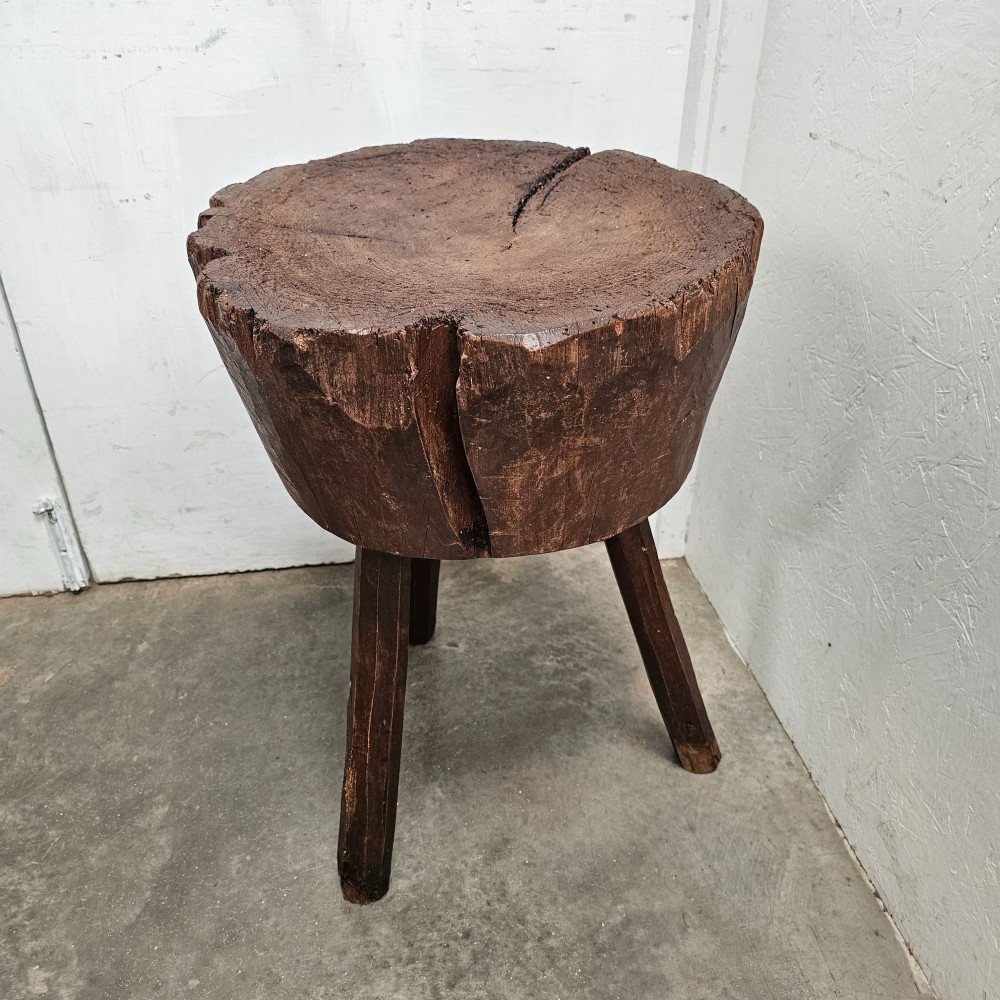 A primitive French beech game block with a carved timber top supported by three splayed wooden legs. View III