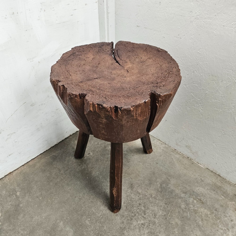 A primitive French beech game block with a carved timber top supported by three splayed wooden legs. View IV