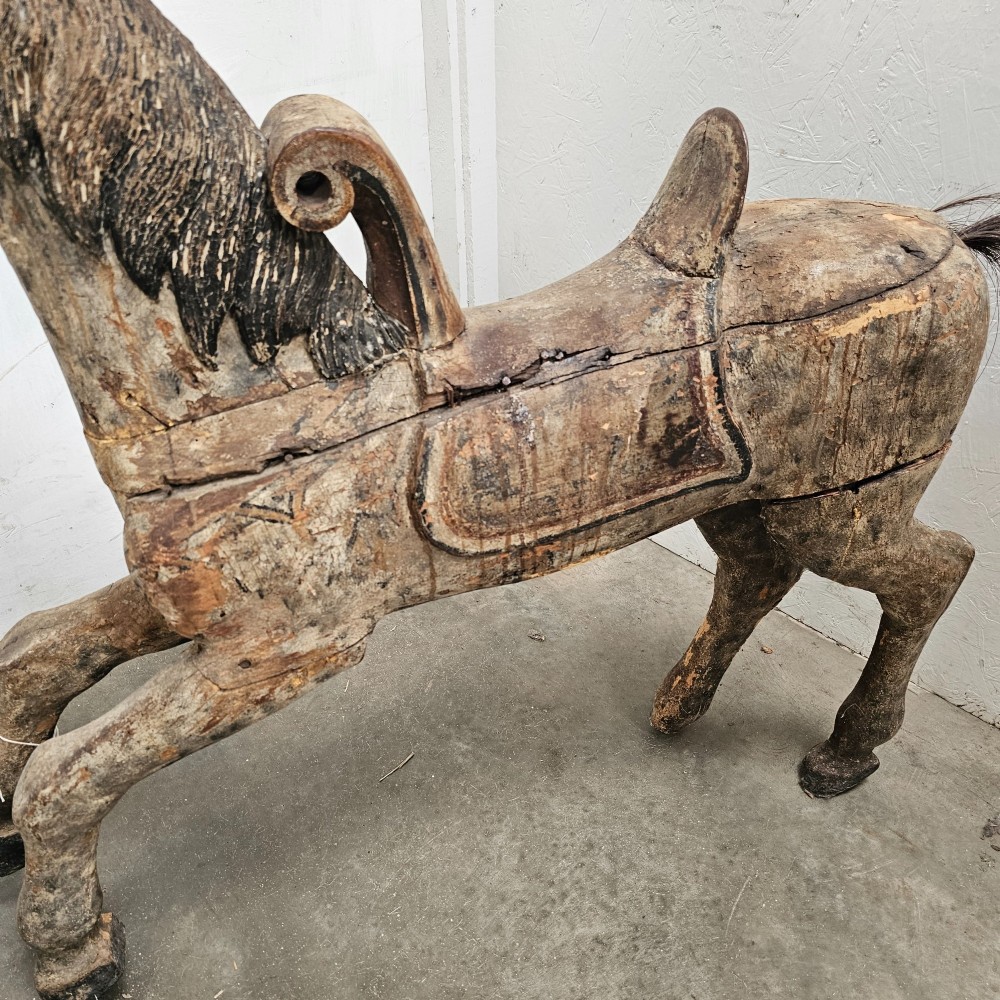 A 19th-century French hand-carved wooden carousel horse featuring a prancing pose, carved saddle, black painted mane, and weathered grey-brown timber finish. View III