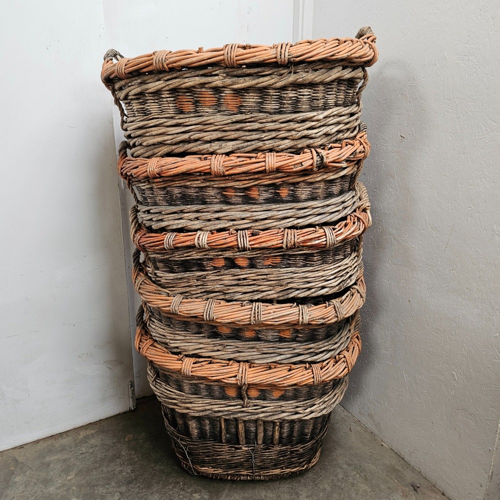 A large, rustic hand-woven willow French champagne harvest basket with woven rim detailing and integrated side handles. View III