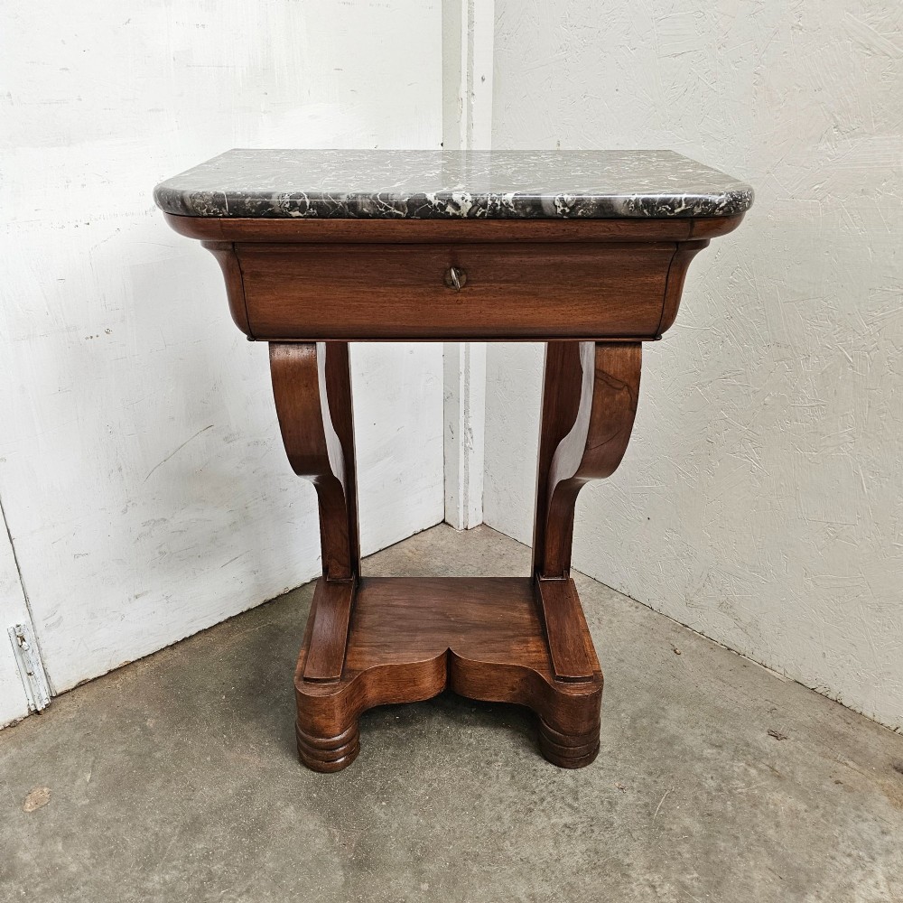 A French walnut console table featuring a grey veined marble top, a single frieze drawer, shaped upright supports, and a shaped plinth base.