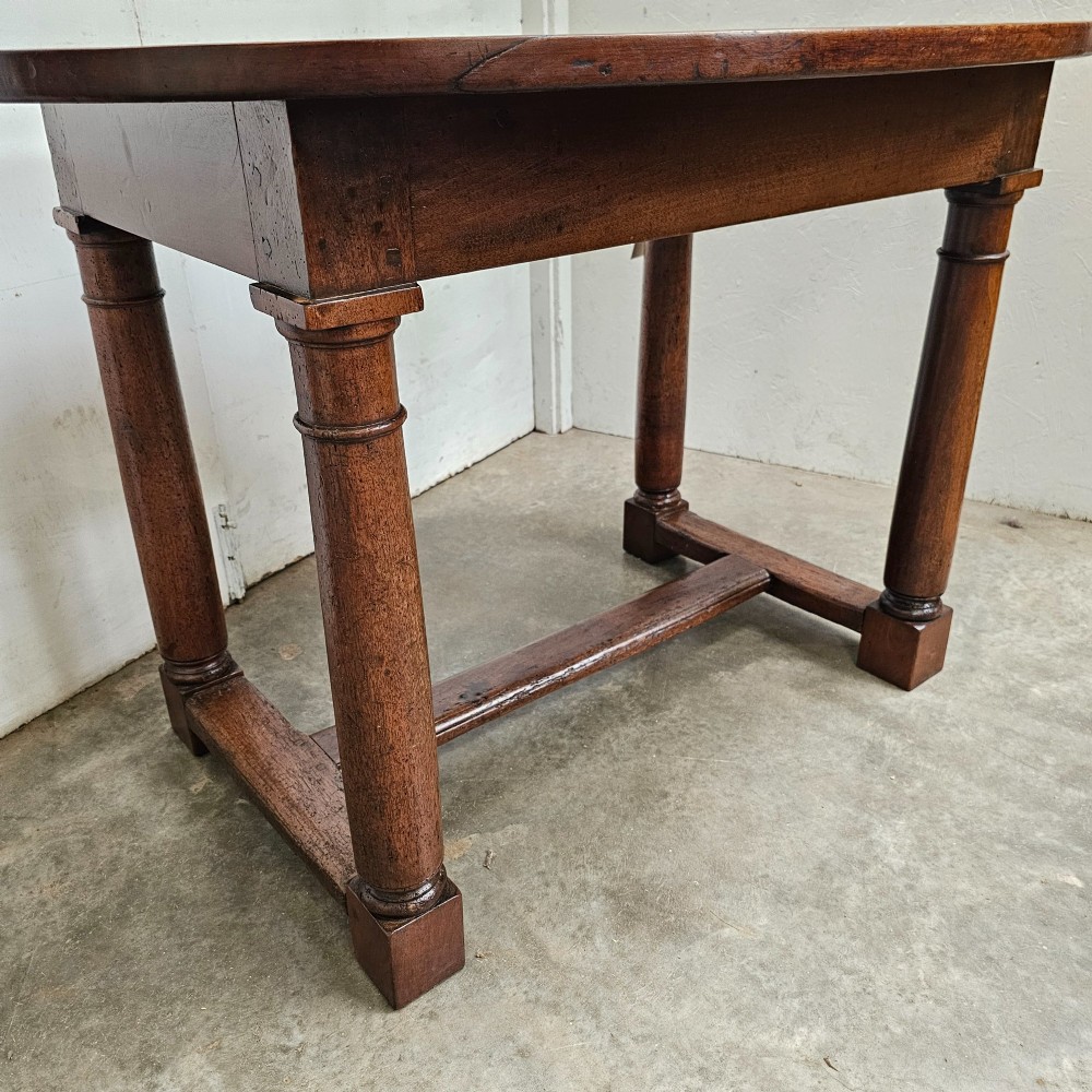 An 18th-century French oval walnut table featuring four turned legs joined by a low H-stretcher. View II