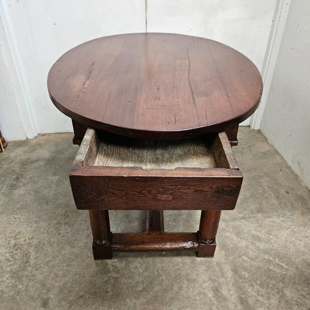 An 18th-century French oval walnut table featuring four turned legs joined by a low H-stretcher. View IV