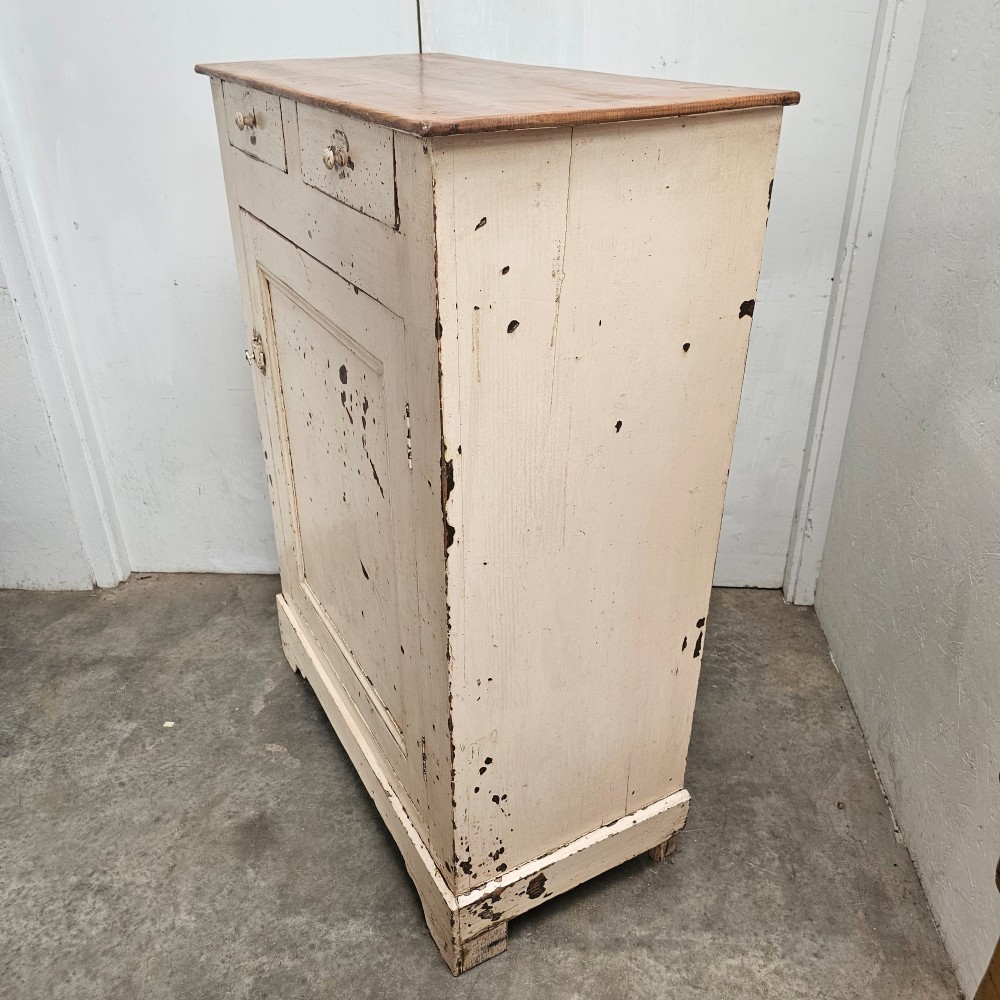 A small painted pine French confiturier cupboard with two upper drawers, a single panelled door, an off-white distressed paint finish, and a natural timber top surface. View II