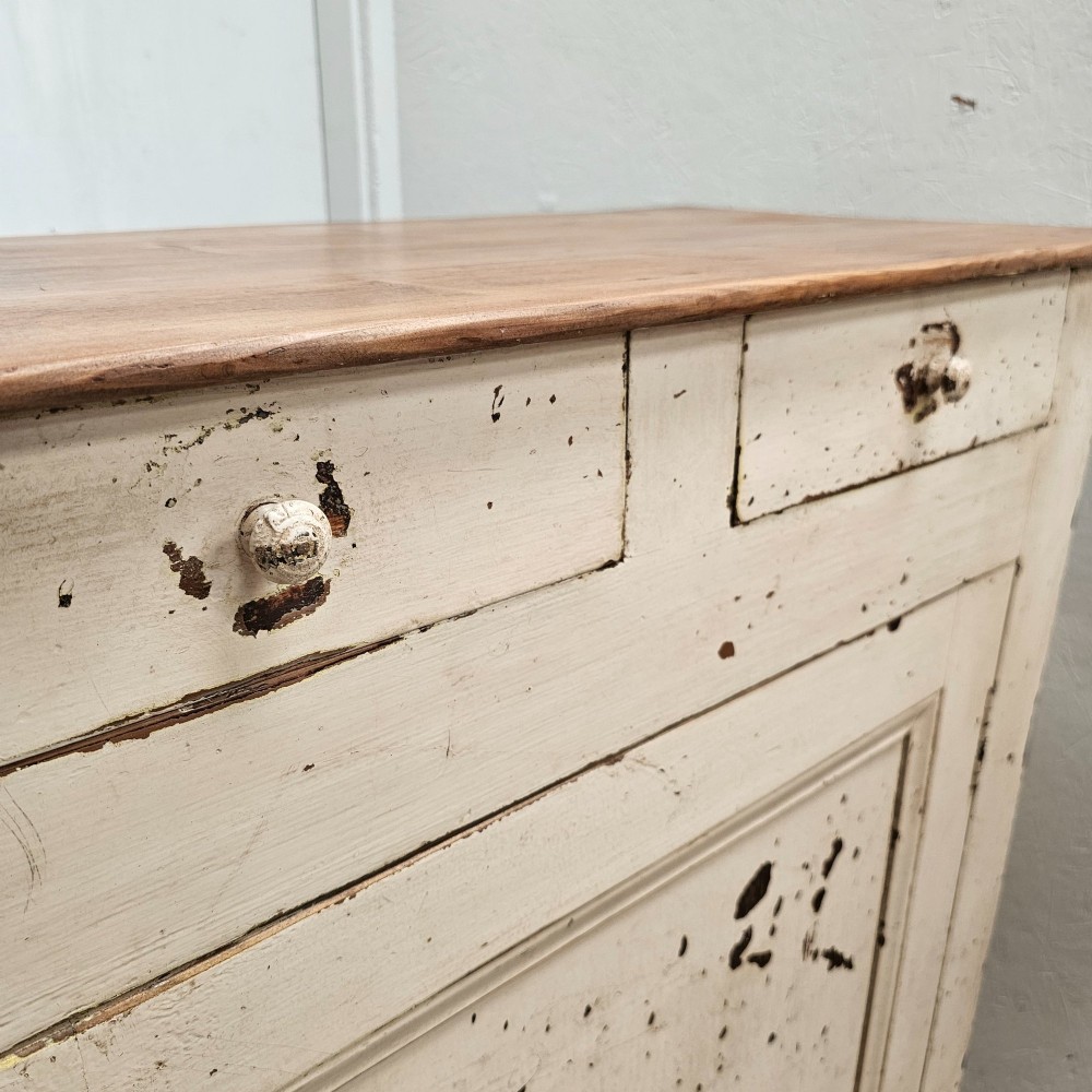 A small painted pine French confiturier cupboard with two upper drawers, a single panelled door, an off-white distressed paint finish, and a natural timber top surface. View IV