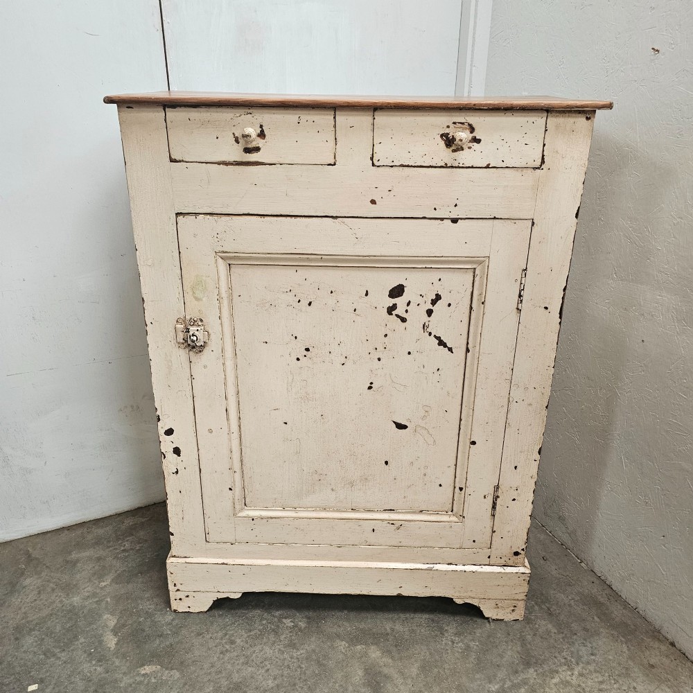 A small painted pine French confiturier cupboard with two upper drawers, a single panelled door, an off-white distressed paint finish, and a natural timber top surface. View VI