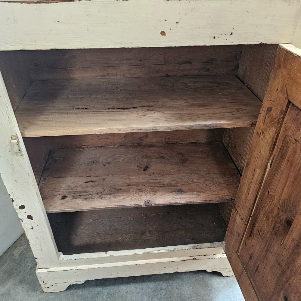A small painted pine French confiturier cupboard with two upper drawers, a single panelled door, an off-white distressed paint finish, and a natural timber top surface. View VII