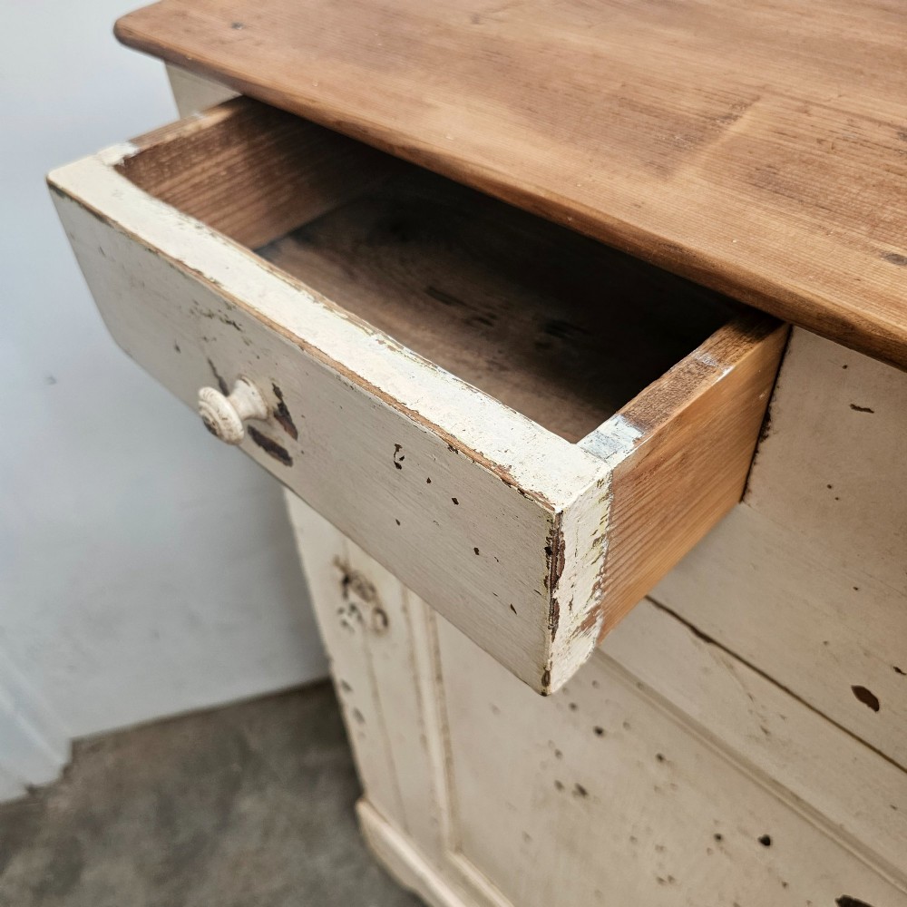 A small painted pine French confiturier cupboard with two upper drawers, a single panelled door, an off-white distressed paint finish, and a natural timber top surface. View VIII
