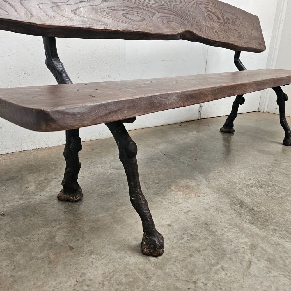 A rustic French garden bench featuring a dark elm slab seat and backrest supported by black cast iron legs designed to resemble natural tree branches. View II